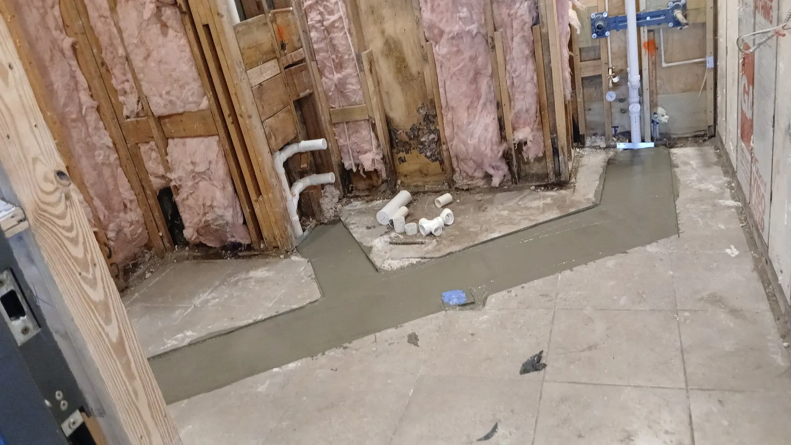 Floor patching and plumbing rough-in during commercial repipe